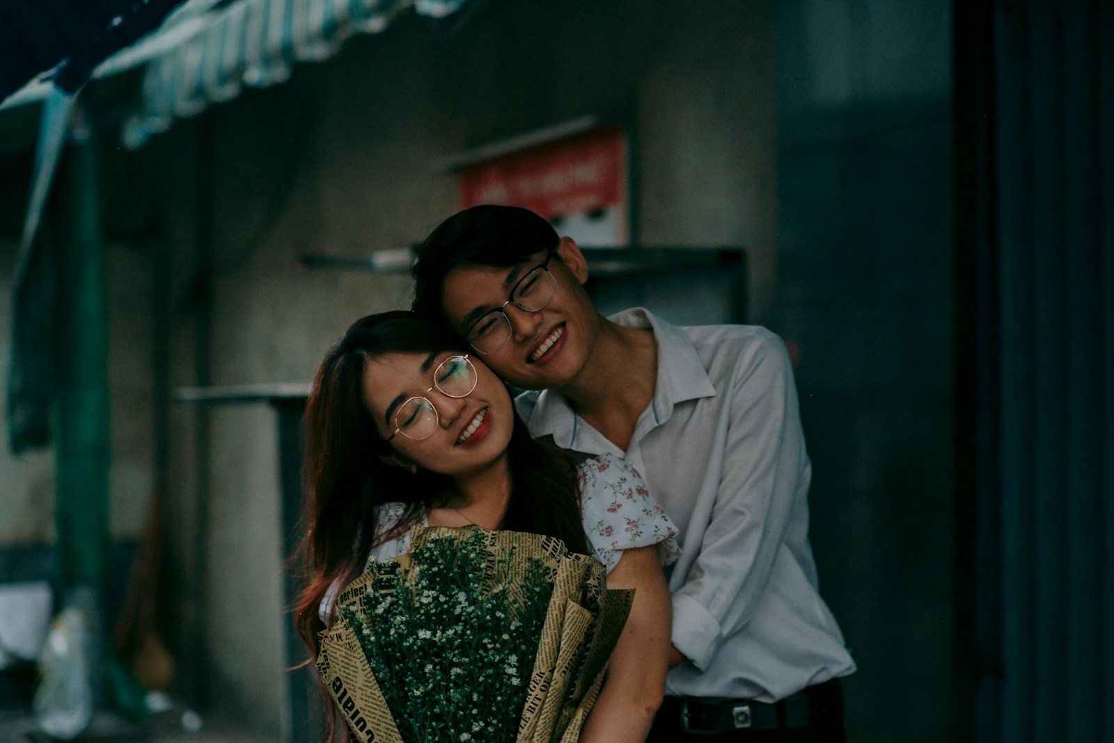 a man holding a bouquet of flowers next to a woman